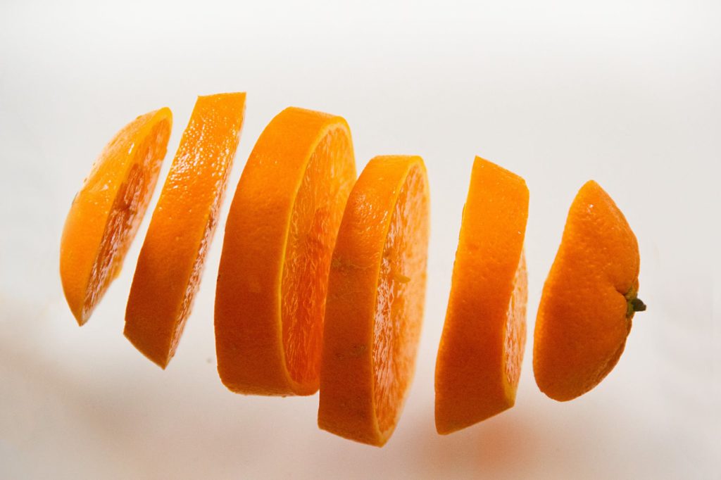 orange sliced up vertically with peel on