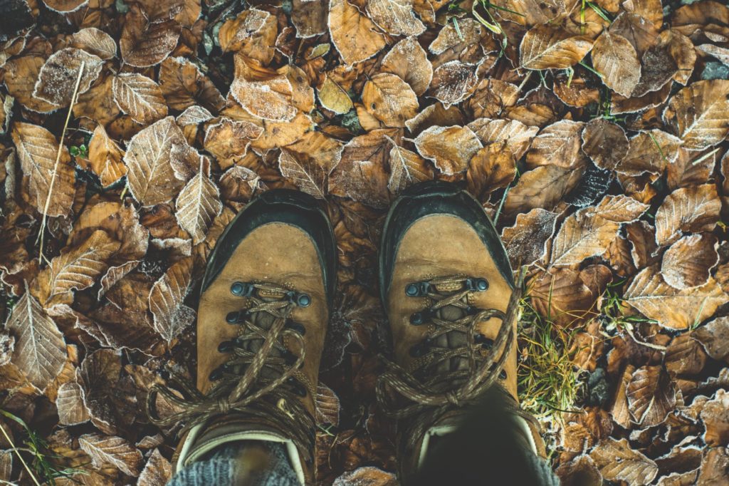 hiking boots on brown leaves outside