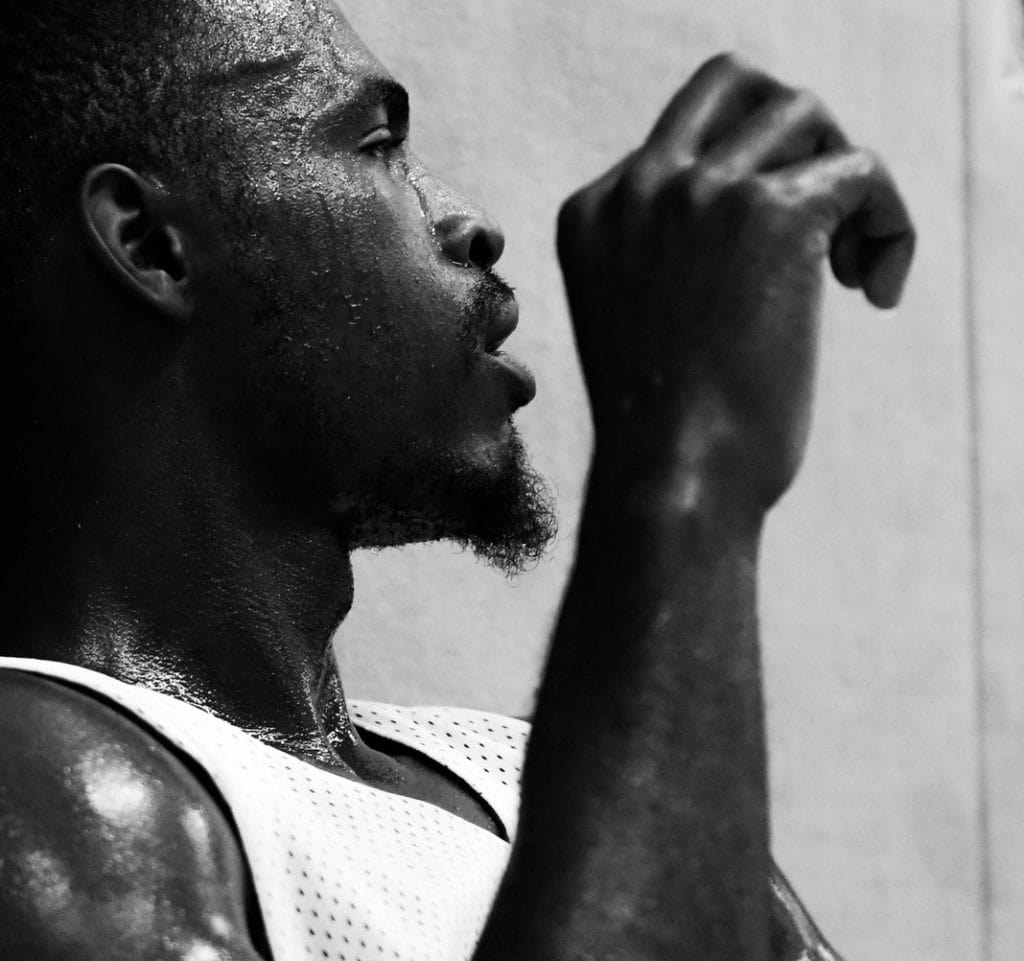 black and white photo, guy sweating in basketball jersey