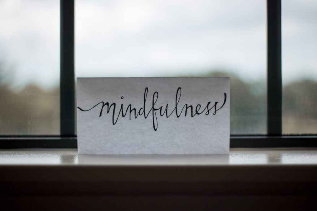 piece of paper in the window with mindfulness written on it
