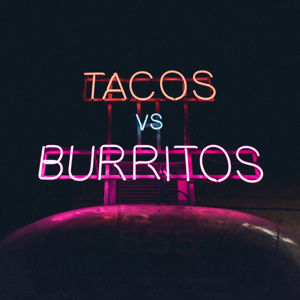 neon sign tacos vs burritos