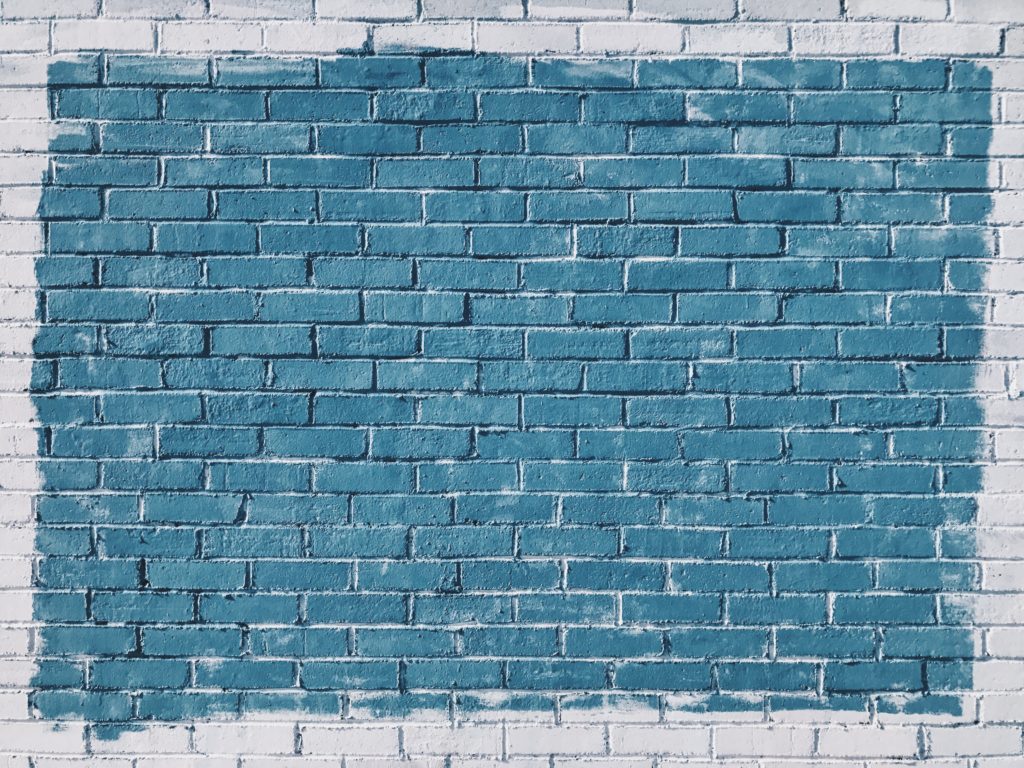 white brick wall painted blue