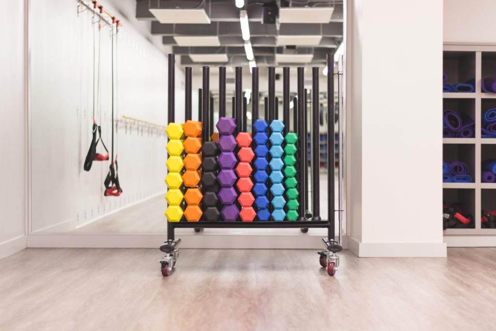 colorful dumbbells stacked up 