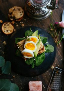 spinach on a plate with a soft boiled egg