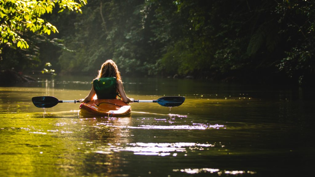 girl kayaking on a river