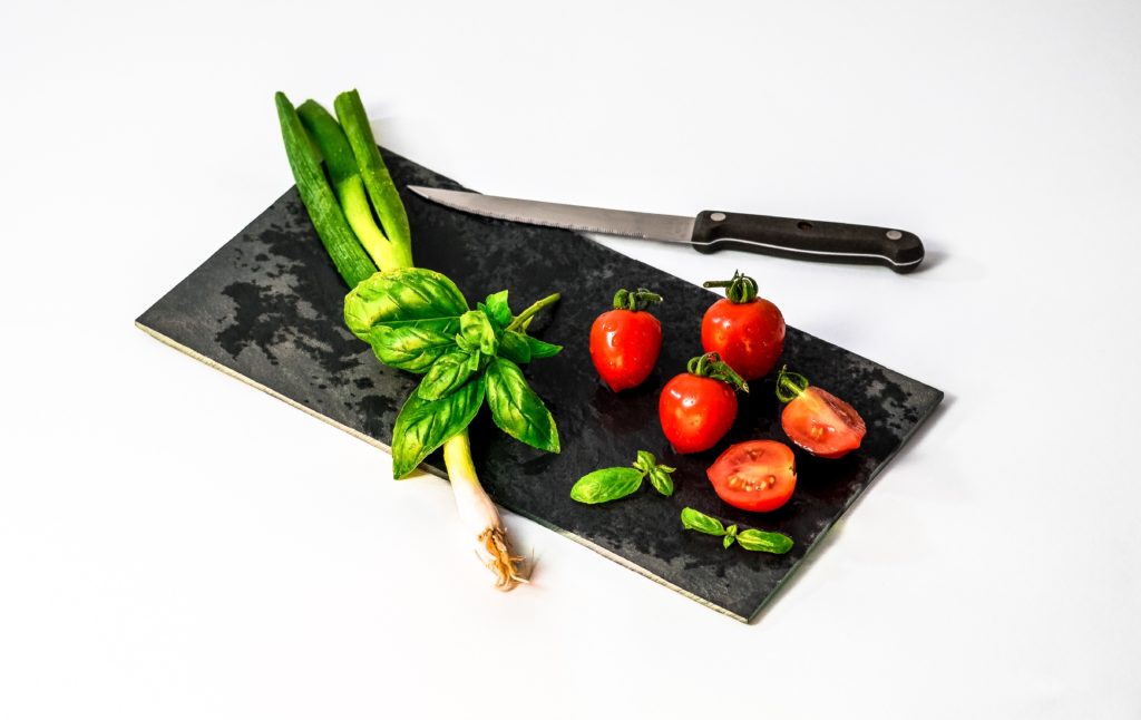 vegetables on a cutting board with knife