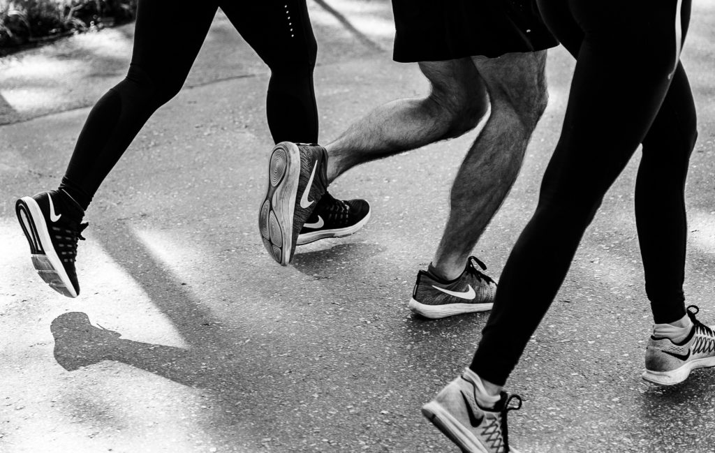 black and white photo of runners outside