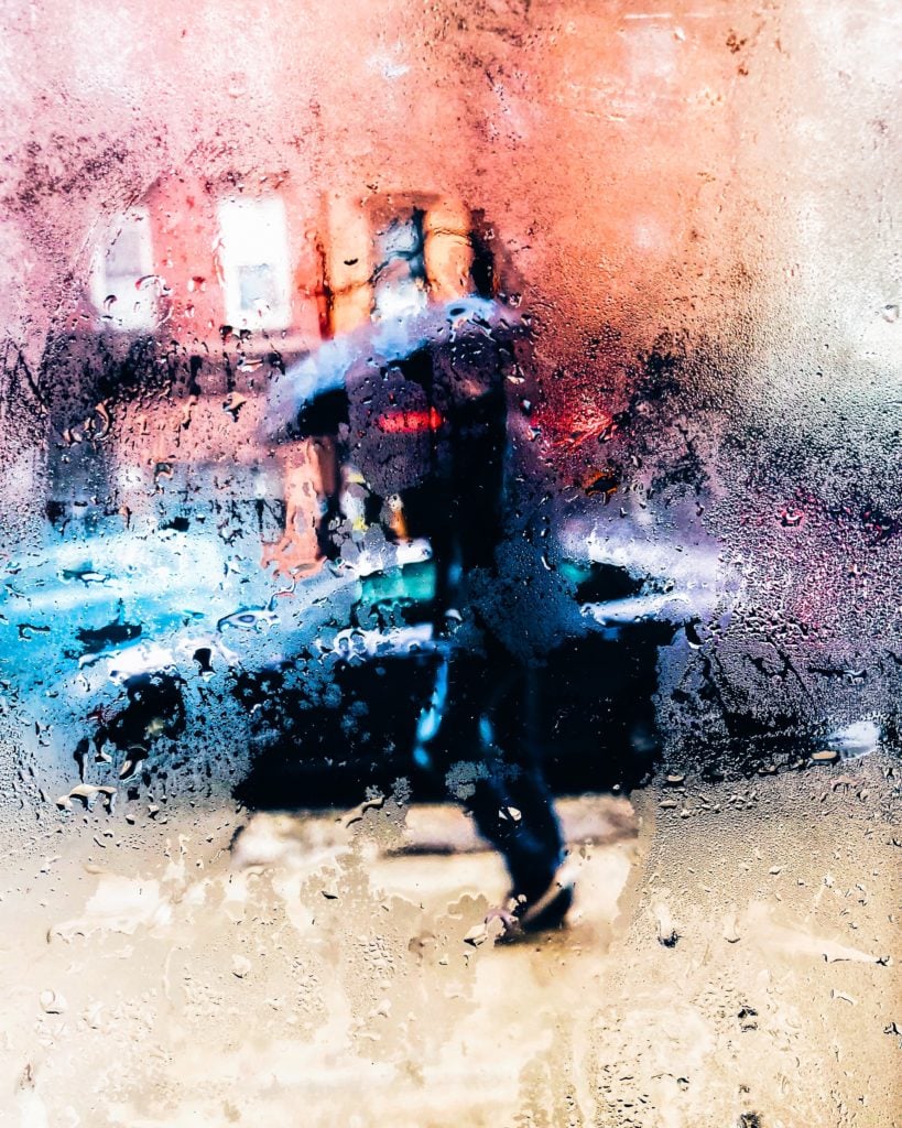 raining through window, person with umbrella