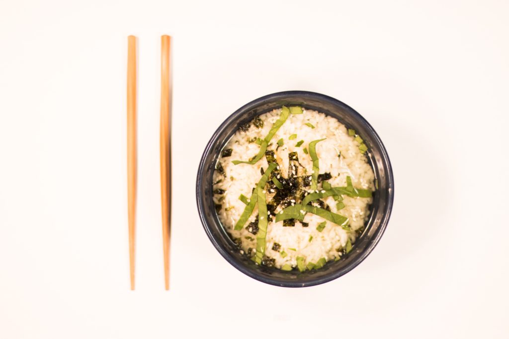bowl of white rice with chop sticks