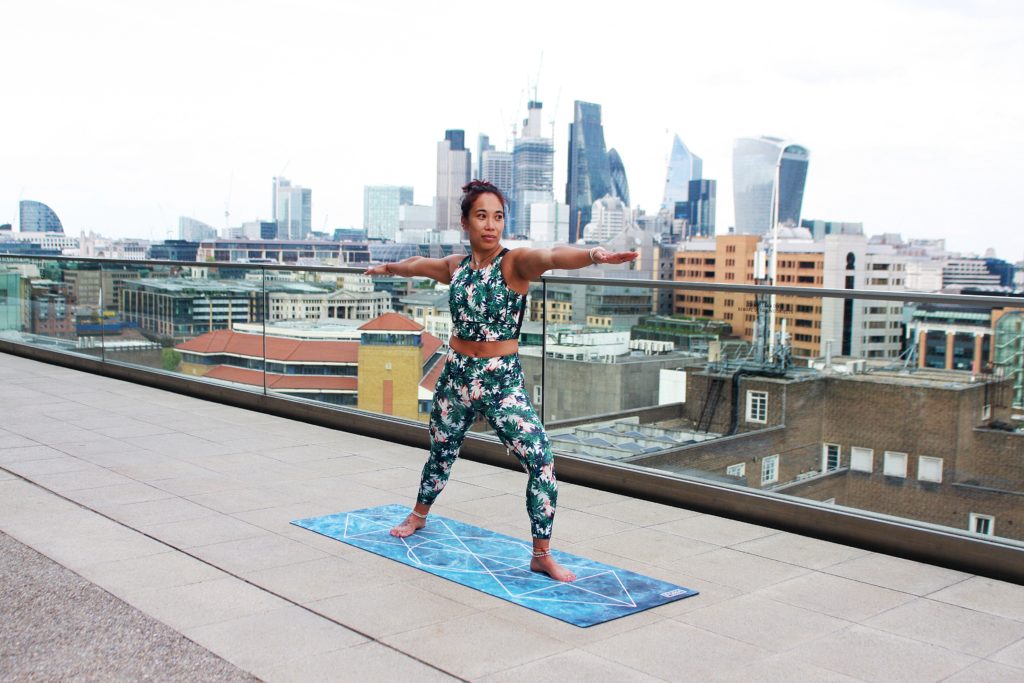 woman on a roof top doing yoga