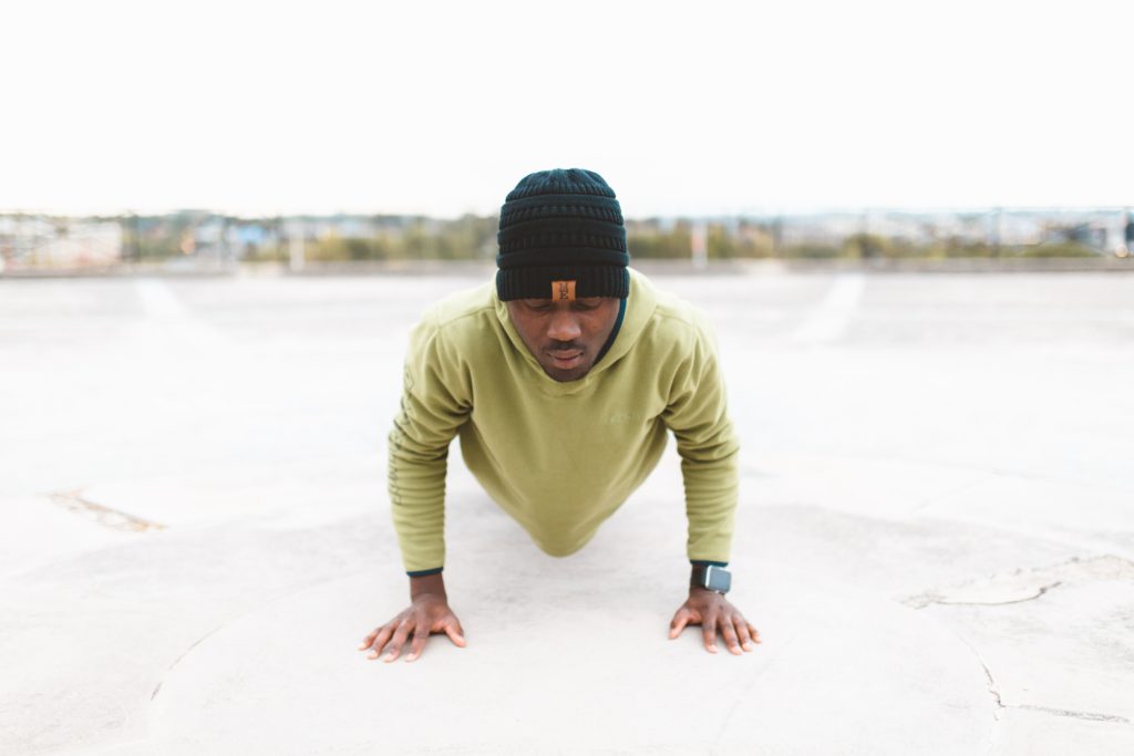 man performing a push up in a plank positin
