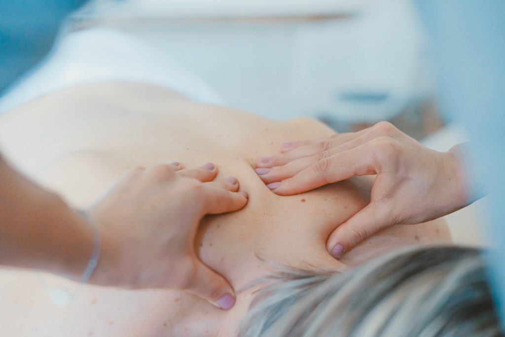 women getting her back rubbed in a massage