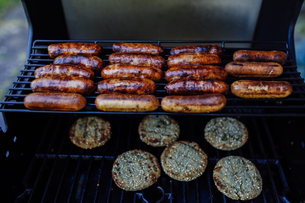 sausages and burgers on a grill