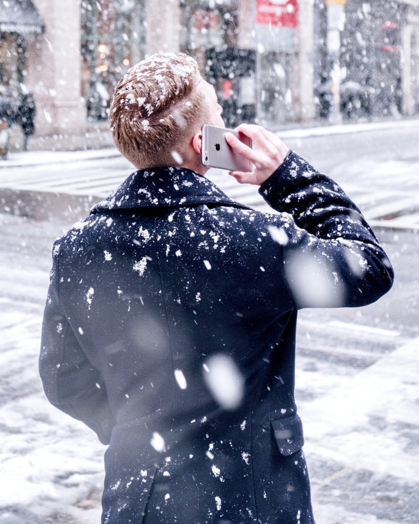 man talking on a cell phone in the snow