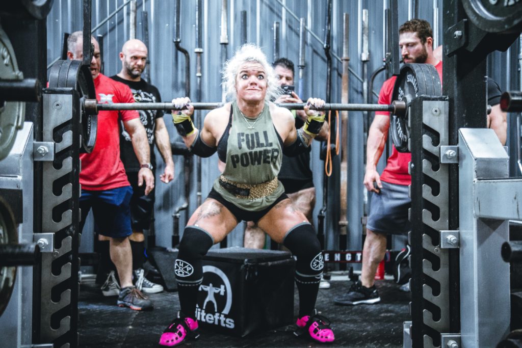 female heavy squat with tough face