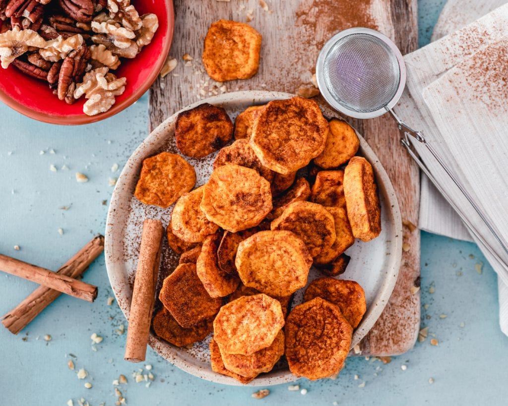diced up sweet potatoes on a plate with cinnamon