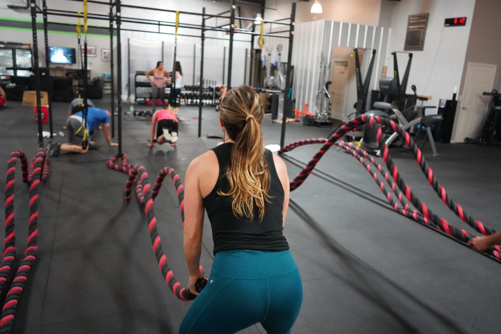 girl working out with battle ropes