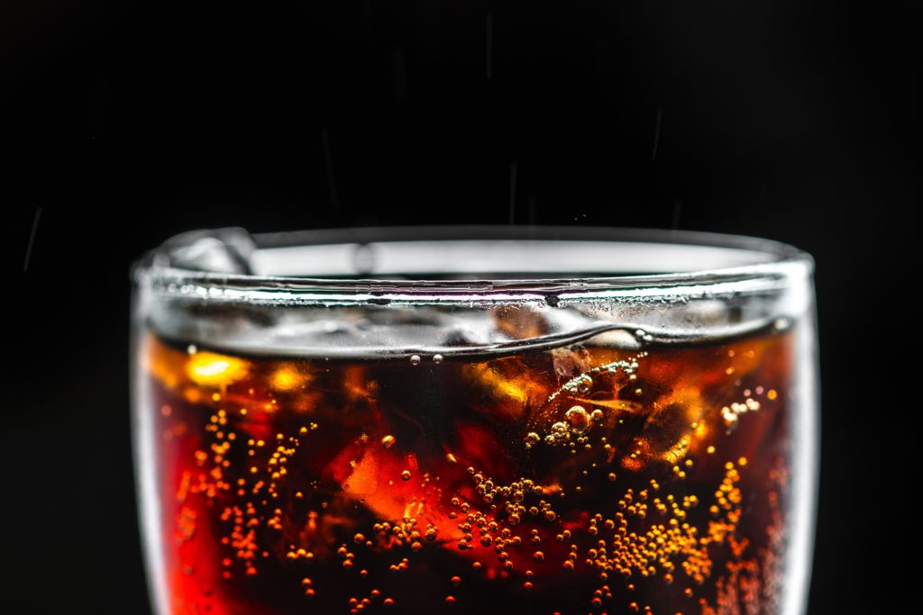 soda in a glass with black background