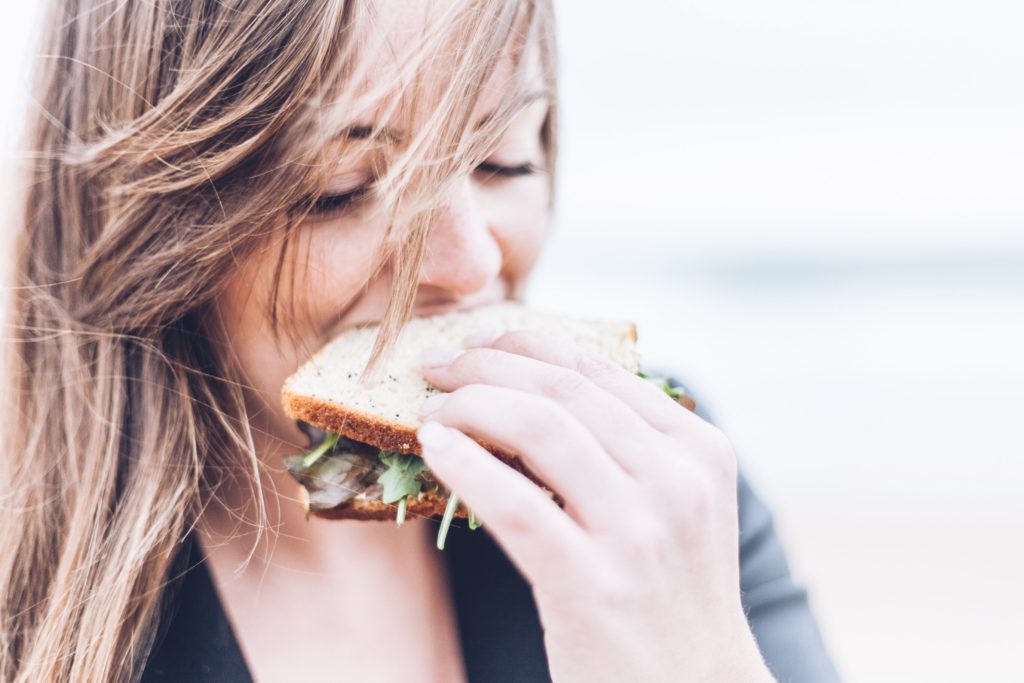 women eating a veggie sandwich
