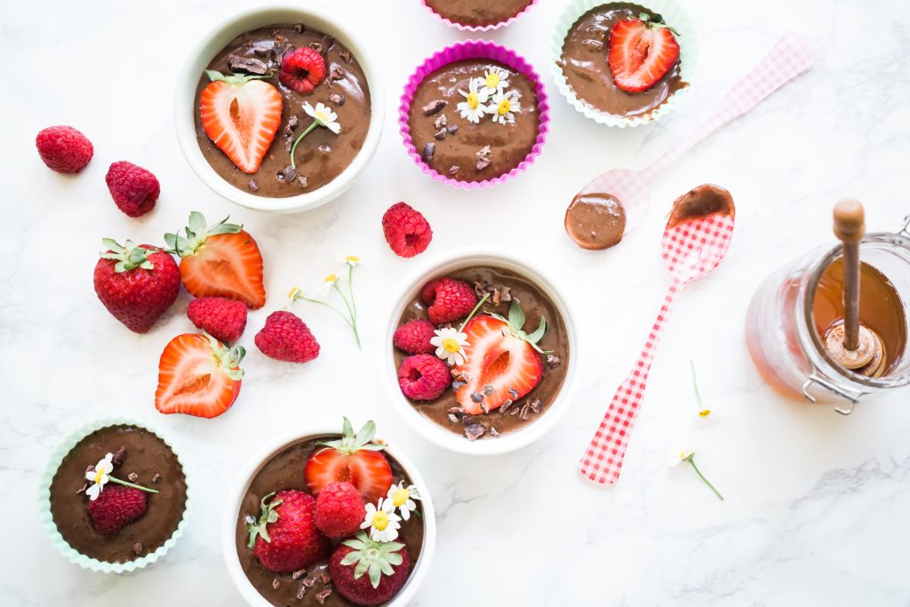 chocolate pudding in ramekins with strawberries