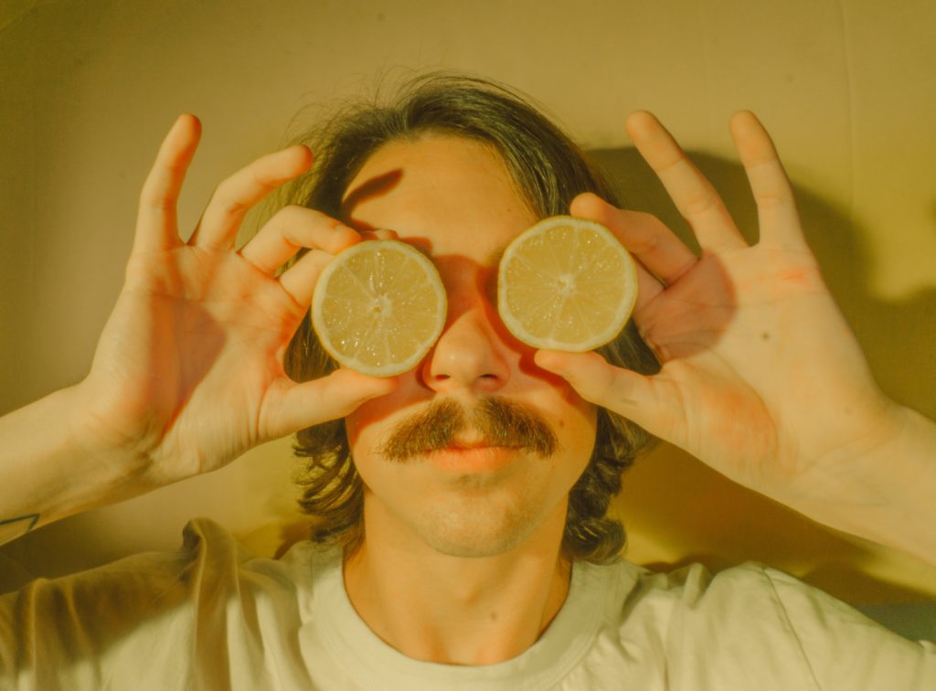 person holding lemons on their eyes
