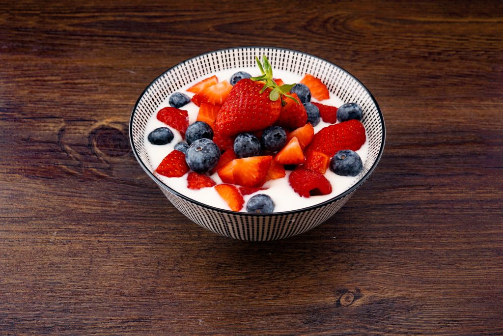 yogurt in a bowl with fruit on top