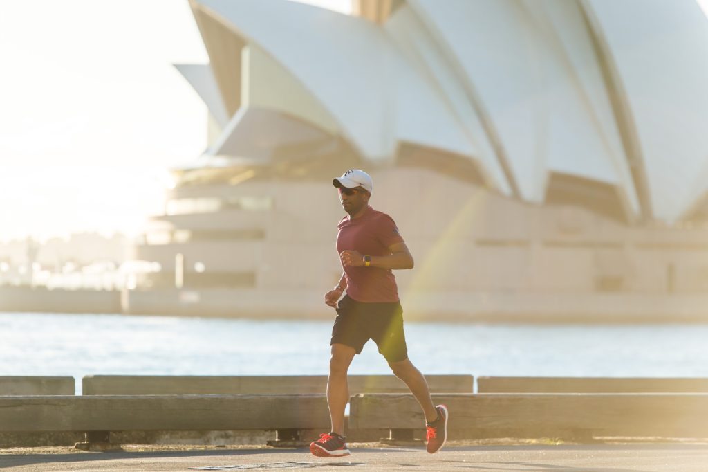 man running along the bay in Sydney